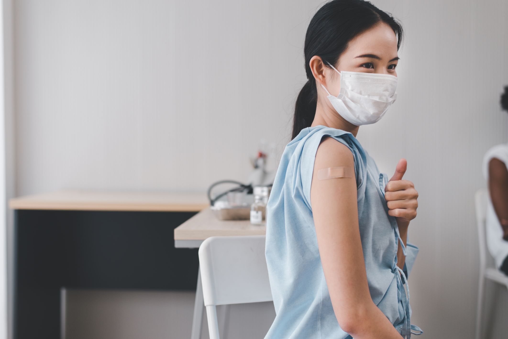 asian-women-showing-adhesive-bandage-plaster-arm-after-getting-vaccinated.jpg