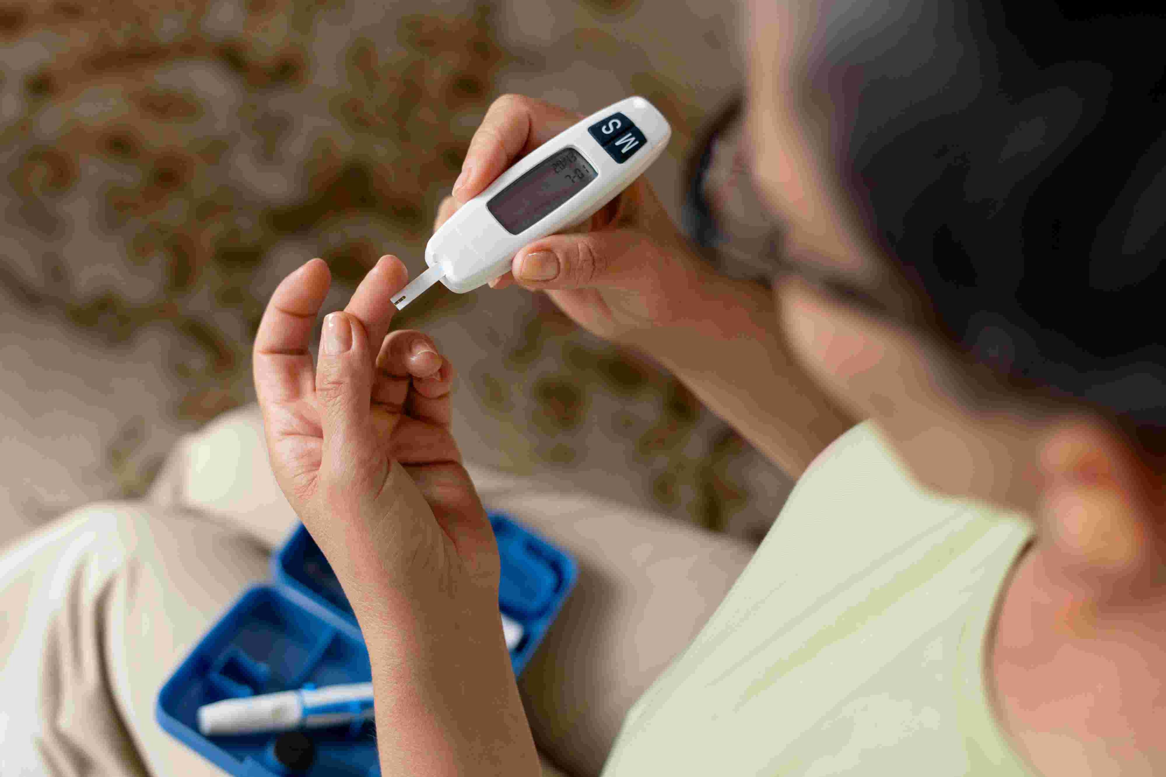 high-angle-diabetic-woman-checking-her-glucose-level.jpg