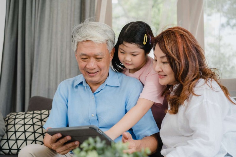 asian-grandparents-granddaughter-using-tablet-home-senior-chinese-grandpa-grandma-happy-spend-family-time-relax-with-young-girl-checking-social-media-lying-sofa-living-room-concept.jpg